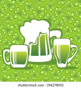 Three green beer mugs on a clover background.
