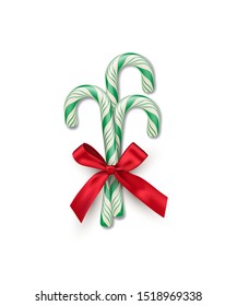 Three green striped candy canes with red bow isolated on white background. Vector Christmas and New Year design element