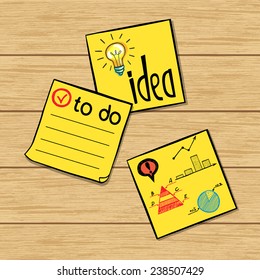 Three hand drawn classic yellow paper stickers with doodle sketches and notes on them. Yellow memo sticks on wooden table background.