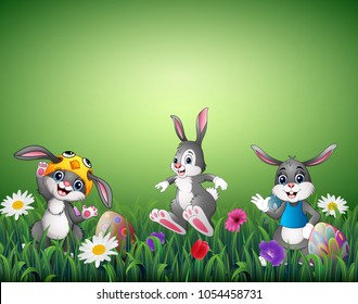 Three happy cartoons with decorated Easter eggs in a field