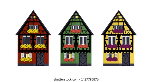 Three houses of different colors in Alsaces style. Green, red and yellow houses in Alsaces style.