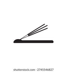 Three incense sticks smoldering on a surface, creating aromatic smoke for meditation.