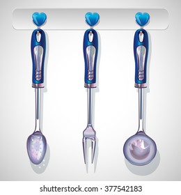 Three kitchen tools hanging on hooks 