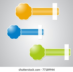 Three label in the form of flowers stuck tape on a gray background