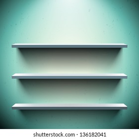 Three lightened shelves on old blue wall