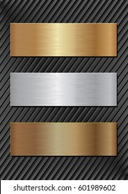 three metal plaques on black background
