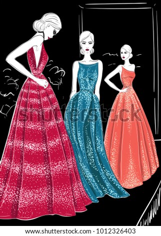 three models in couture dresses catwolk