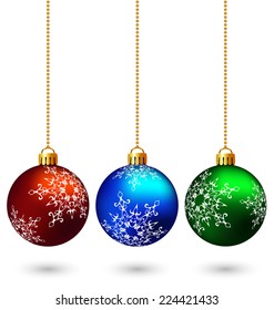 Three multicolored christmas balls hang on the chain isolated on white background