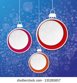 Three paper christmas bauble with snowflakes on the blue background.