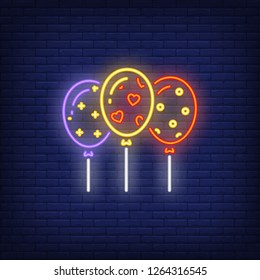 Three patterned balloons neon sign. Party, celebration, birthday design element. Night bright neon sign, colorful billboard, light banner. Vector illustration in neon style.