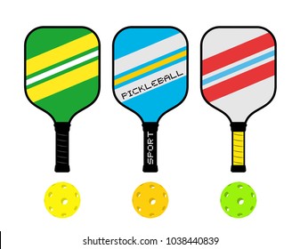 Three pickleball rackets and balls