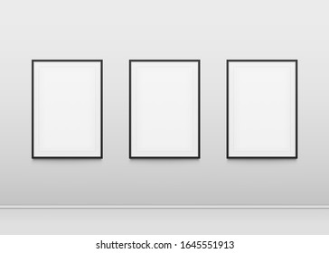 	
Three poster mockup on wall. Poster with a black frame on a white wall