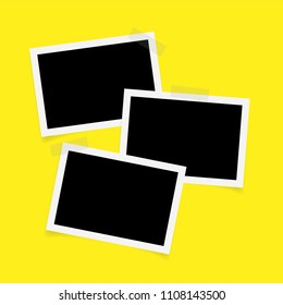 Three rectangle photo frames with sticky tape on yellow background. 