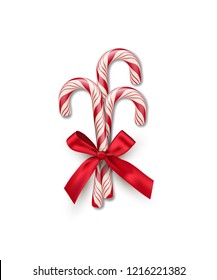 Three red striped candy canes with red bow isolated on white background. Vector Christmas and New Year design element