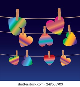 Three rows of colorful hearts on clips at night,symbolising love or the effect of drugs.