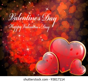 Three shining hearts in a gold frame on a sparkling background. Valentine's Day romantic background.