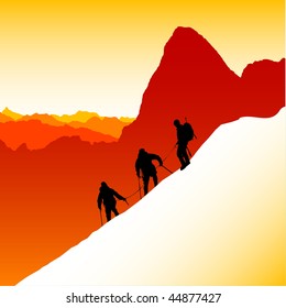  Three silhouetted mountaineers descending a ridge in the French Alps with Mont Blanc in the background