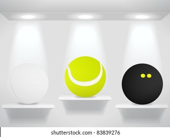 Three sport balls on shelves on the wall