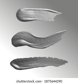Three strokes of paint in shades of gray and silver