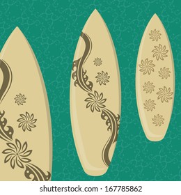 three surfboards with different styles and flowers