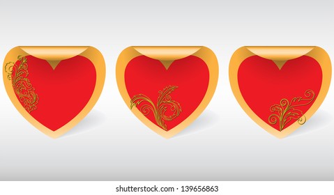 three  swirl golden sticker in the shape of hearts with ornaments