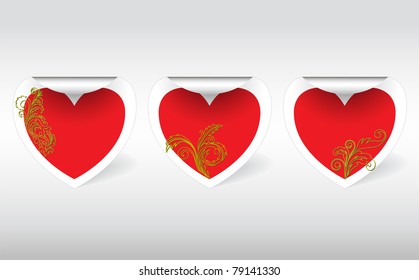 three  swirl sticker in the shape of hearts with golden ornaments