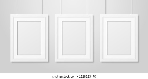 Three Vector Realistic Modern Interior White Blank Vertical A4 Wooden Poster Picture Frame Set Hanging on the Ropes on White Wall Mock-up. Empty Poster Frames Design Template for Mockup, Presentation