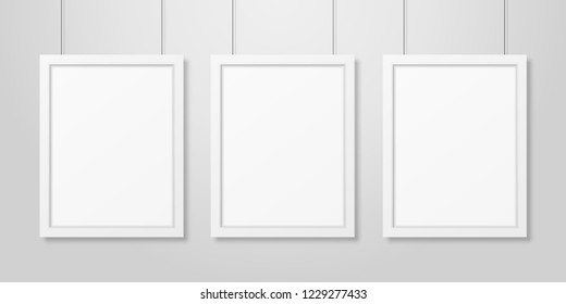 Three Vector Realistic Modern Interior White Blank Vertical A4 Wooden Poster Picture Frame Set Hanging on the Ropes on White Wall Mock-up. Empty Poster Frames Design Template for Mockup, Presentation