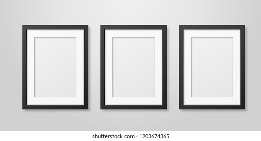 Three Vector Realistic Mofern Interior Black Blank Vertical A4 Wooden Poster Picture Frame Set Closeup on White Wall Mock-up. Empty Poster Frames Design Template for Mockup, Presentation