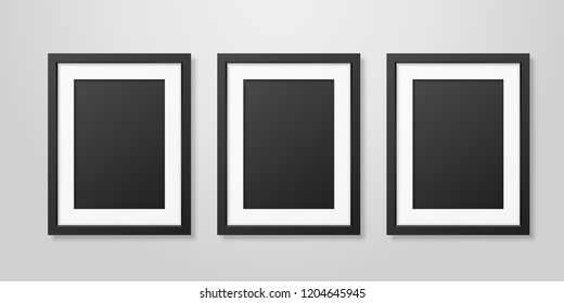 Three Vector Realistic Mofern Interior Black Blank Vertical A4 Wooden Poster Picture Frame Set Closeup On White Wall Mock-up. Empty Poster Frames Design Template For Mockup, Presentation