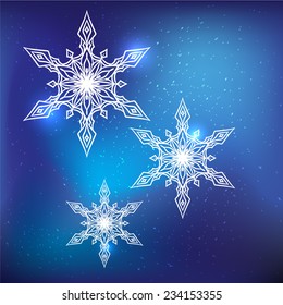 Three vector snowflakes on a blue background