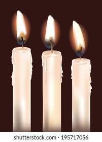 Three white candles isolated on a dark background.