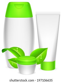 Three white cosmetics containers and green leaves.