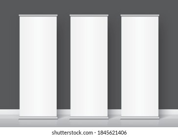 Three white rollup banners standing on the dark grey wall background. The Group of vertical promotional stands for image or text placement. Realistic vector banner template and mockup.