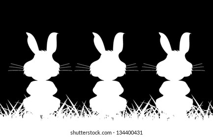 Three white silhouette of a rabbit on a black background