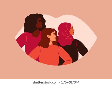 Three women of different nationalities and cultures standing together. Feminists on the background of the female lips. The concept of gender equality and of the female empowerment movement.