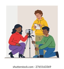Three young people, diverse in ethnicity, collaborate on a video production, adjusting a smartphone on a tripod.