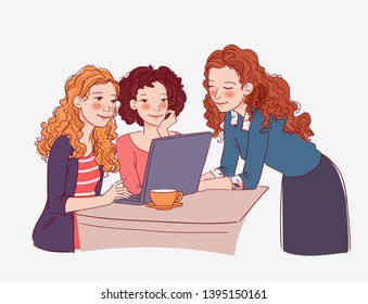 Three young women sitting at the table and looking for something on the Internet