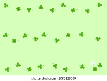 Three-leaf and four-leaf clover lined up on a light green background