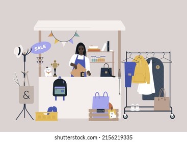 A thrift shopping concept, a Sunday market stand with used clothes and accessories