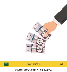 Throwing three riyal. Saudi Arabian riyal banknote.