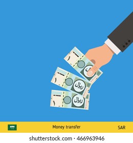 Throwing three riyal. Saudi Arabian riyal banknote.