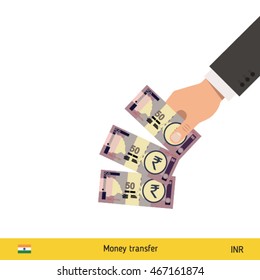 Throwing three rupee. Indian rupee banknote.