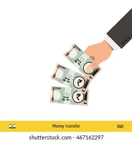 Throwing three rupee. Indian rupee banknote.