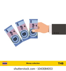 Throwing three Thai baht. Thai baht banknote.