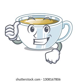 Thumbs up ginger tea above character wooden table