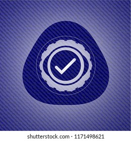 tick icon inside badge with denim background