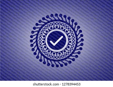 tick icon inside badge with denim texture