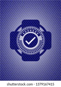 tick icon inside badge with denim texture