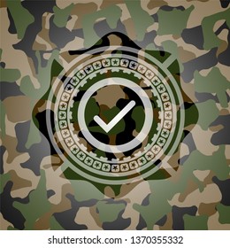 tick icon inside camouflage emblem